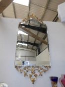An ormolu gilt framed bevel edged mirror.