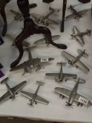A quantity of unboxed white metal aircraft.