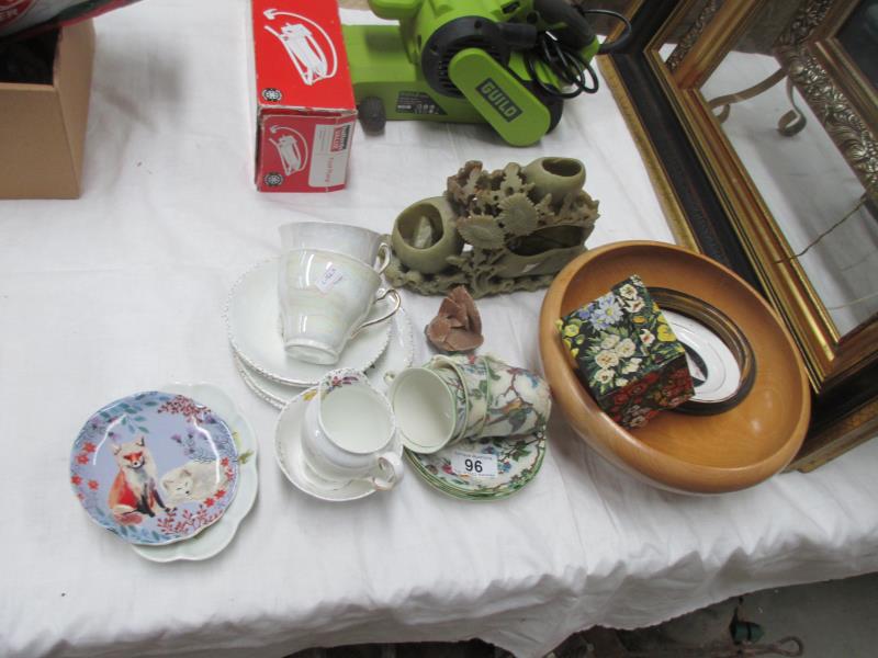 A soapstone group a/f and three Burslem Brama cups and saucers