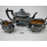 A silver plate three piece tea set with gilded interior (in need of cleaning).