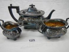 A silver plate three piece tea set with gilded interior (in need of cleaning).