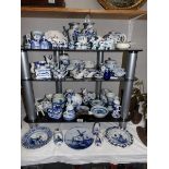 A large quantity of Delft hand painted items including salt and pepper pots.