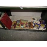 A quantity of old books, boxed die cast cars, 2 Scottish dolls etc.