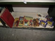 A quantity of old books, boxed die cast cars, 2 Scottish dolls etc.