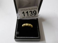 A yellow gold diamond set rope style ring, size J.