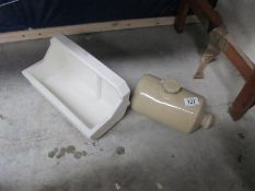 A ceramic trough and old hot water bottle