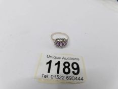 A 9ct yellow gold 3 stone amethyst and diamond oval ring.