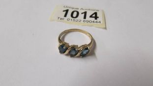 A 9ct gold ring set 3 blue gem stones, size P half.