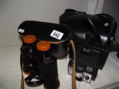 A vintage Polaroid square shooter 2 instant camera and a Swift tecnar 8 x 40 binoculars.