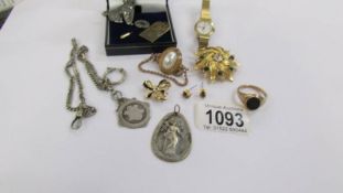 A small mixed lot of costume jewellery including silver watch fob.