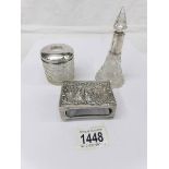 A silver topped hair pot, a scent bottle and a matchbox holder.