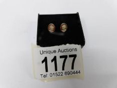 A pair of 9ct yellow gold small cameo earrings.