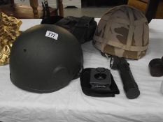 A Konustar compass, 2 military helmets, a belt with pouch and torch.