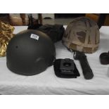 A Konustar compass, 2 military helmets, a belt with pouch and torch.