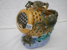 A porcelain model of a crab pot.