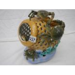 A porcelain model of a crab pot.