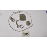 A silver vesta (24 grams), 2 silver rings (11 grams) a white metal locket on a chain.