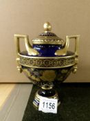 A fine blue & gold glazed Dresden porcelain lidded two handled urn signed by the artist.