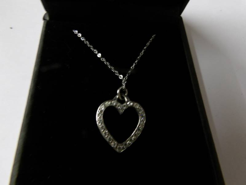 A white gold diamond set heart shaped pendant on gold chain. - Image 2 of 2