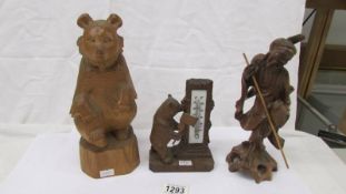 A carved bear thermometer, a large carved bear and a carved Chinese figure.