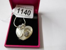 A silver and blister pearl heart shaped pendant necklace.
