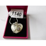 A silver and blister pearl heart shaped pendant necklace.