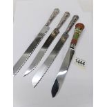 3 hall marked silver handled bread knives and one other.