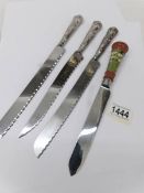 3 hall marked silver handled bread knives and one other.