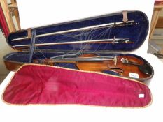 An old violin in wooden case - violin has label reading 'The Antiquary 1763' and a signature in pen