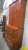 A George III mahogany secretaire cabinet with moulded cornice above a pair of rectangular veneered