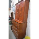 A George III mahogany secretaire cabinet with moulded cornice above a pair of rectangular veneered