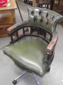 A green leather deep buttoned swivel office chair (collect only).