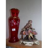 A tall Italian overlaid ruby glass vase and a Capi di Monte figure,