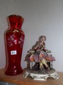 A tall Italian overlaid ruby glass vase and a Capi di Monte figure,