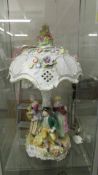 A fine figural porcelain table lamp with large parasol shade, top finial a/f.