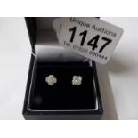 A pair of 18ct white gold diamond four leaf clover earrings of 20 points.