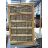 A small cane 5 drawer chest of drawers