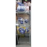 A 4 tiered glass shelf unit and a quantity of blue and white china all a/f