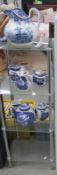 A 4 tiered glass shelf unit and a quantity of blue and white china all a/f