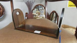 A 19th century oak expanding book rack with carved fretwork hinged ends.