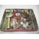 A box of coins and a large tin of foreign, UK coins and bank notes.