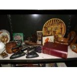 A mixed shelf of wooden items, collectable tins, large plaster plaque etc.