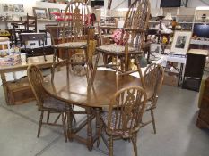 An oak gateleg table and a set of 6 wheelback dining chairs (collect only).