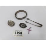 A hall marked silver bangle, sugar tongs, oval brooch, locket and 925 silver cross.