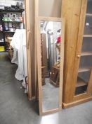 A limed oak effect floor standing mirror, (collect only).