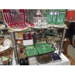 4 shelves of plated flatware, cutlery and other metalware including teapot.