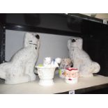 A pair of Victorian Staffordshire spaniels, continental cats in basket etc., all items a/f.