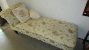 A floral upholstered day bed.