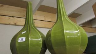 A pair of green glazed vases.