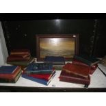 A selection of old books and a signed oil on board of a beach scene.